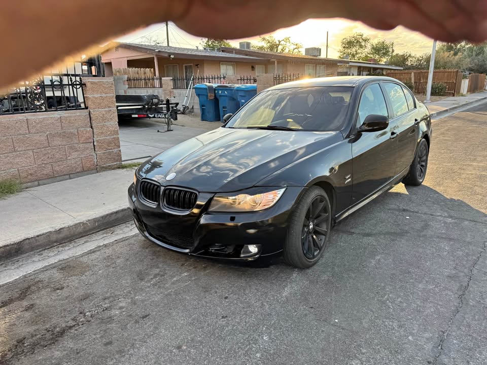 Black BMW sedan gleaming at sunset after full exterior detail