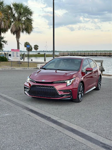 Red Toyota Corolla exterior polished by the waterfront
